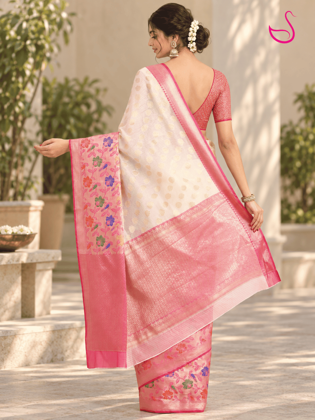 Cream saree back pose with pink floral woven pallu, zari border and matching pink blouse, outdoor styling