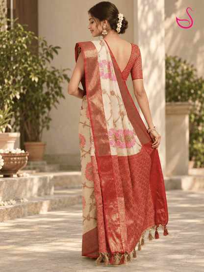 Maroon-red and gold woven blouse with an intricate geometric zari pattern, short sleeves and deep V neckline, designed to complement a cream floral saree.