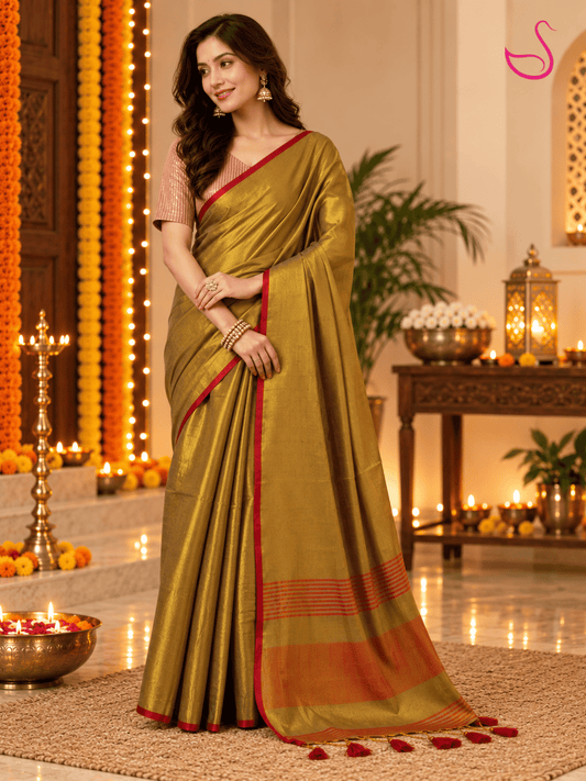 Olive-gold saree with red border and striped pallu styled with a matching textured blouse in a festive Diwali setting