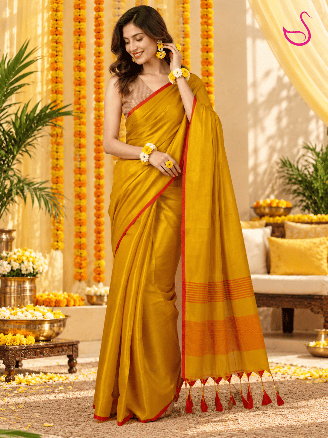 Yellow saree with red border, striped blouse and detailed pallu styled for a Haldi ceremony