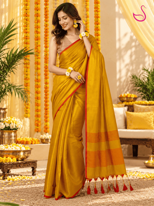 Yellow saree with red border, striped blouse and detailed pallu styled for a Haldi ceremony