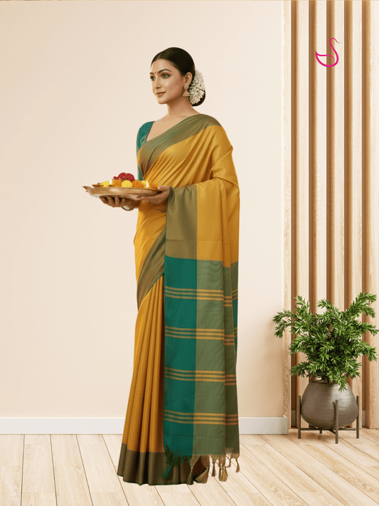 Mustard yellow tissue silk saree with dark green border and pallu